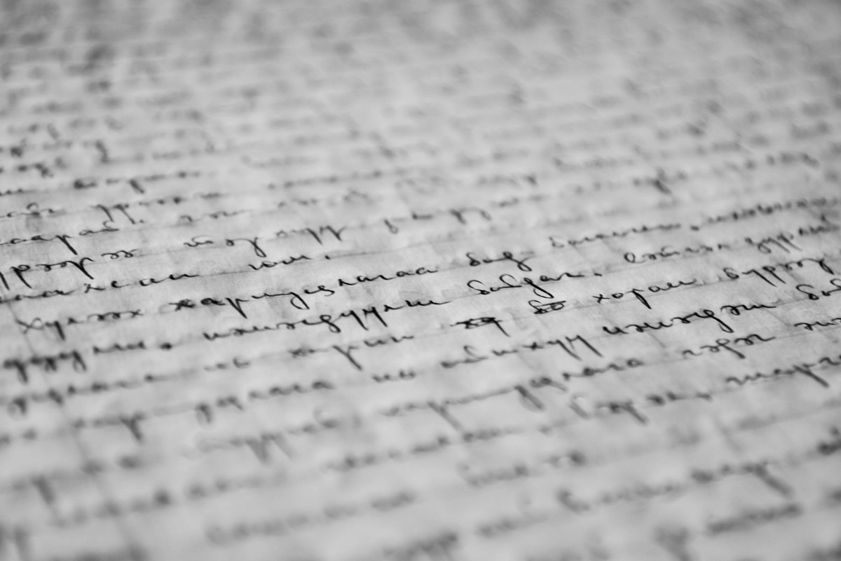 Black and white illustration of a handwritten text on a piece of paper.