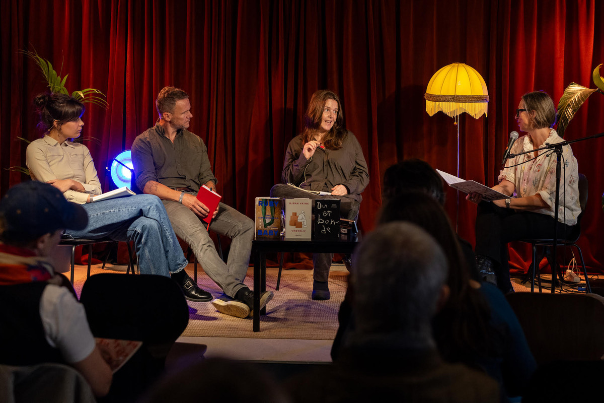 Four people engaging in debate. 